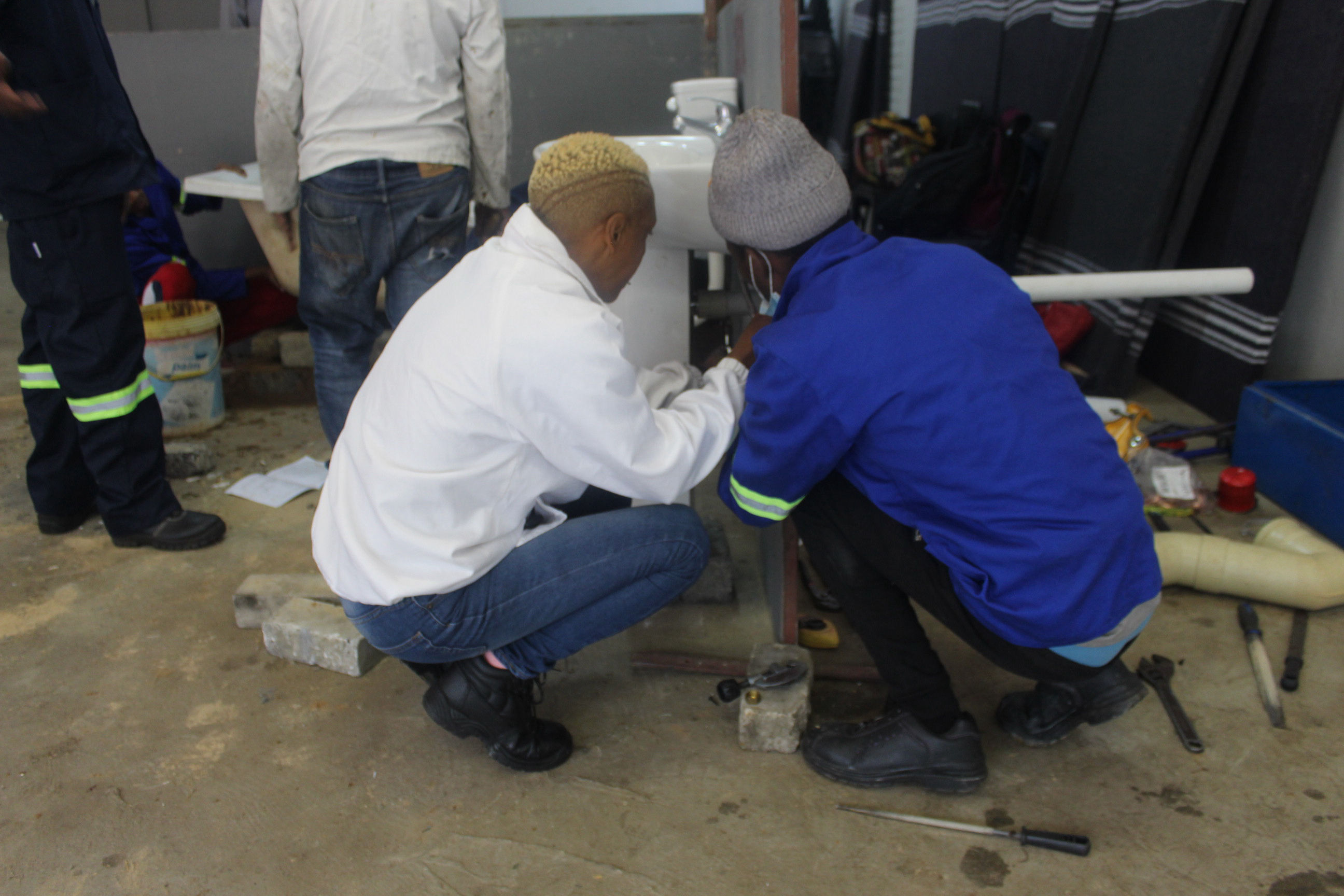 Students are given hands-on training in plumbing in the Outreach Foundation introduction to plumbing course